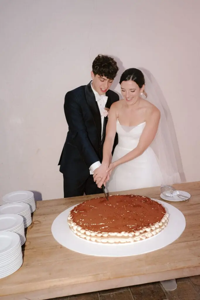 Couple cutting their giant tiramisu at Villa Alma Nita