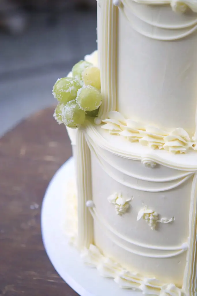Sugared green grapes and piped drapes on a vintage wedding cake