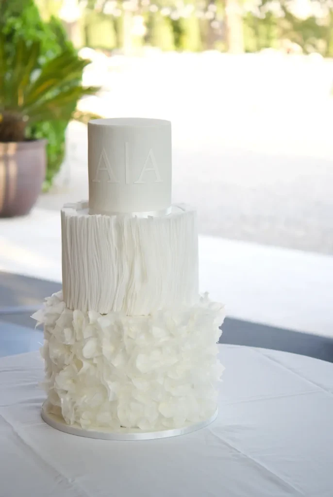 Three-tier wafer paper wedding cake with three different white textures