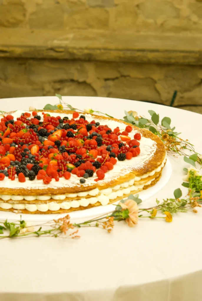 Fresh mixed berries on top of a giant 80 cm millefoglie wedding dessert