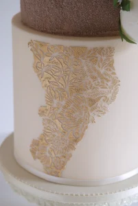 Ivory roses and gold wedding cake