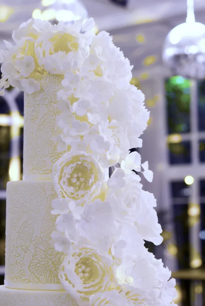 Handcrafted sugar peonies, anemones and English roses on a luxury wedding cake