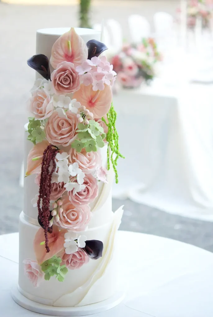 Botanical Blush wedding cake with a cascade of sugar flowers at Castell de Sant Marçal, Barcelona