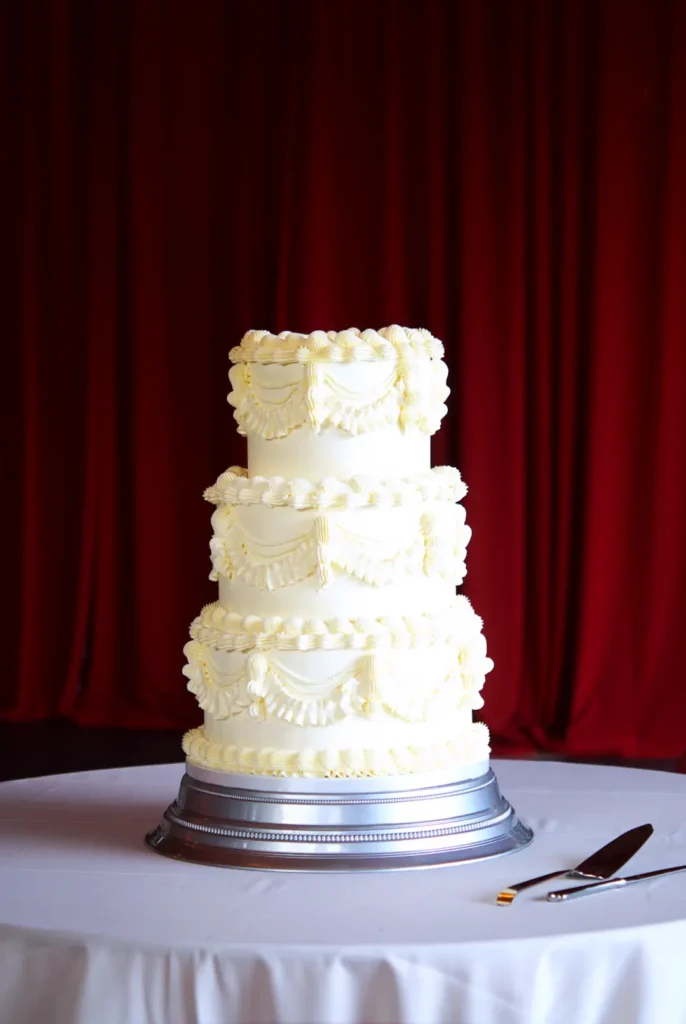Three-tier Lambeth wedding cake in white buttercream at Castell de Sant Marçal, Barcelona