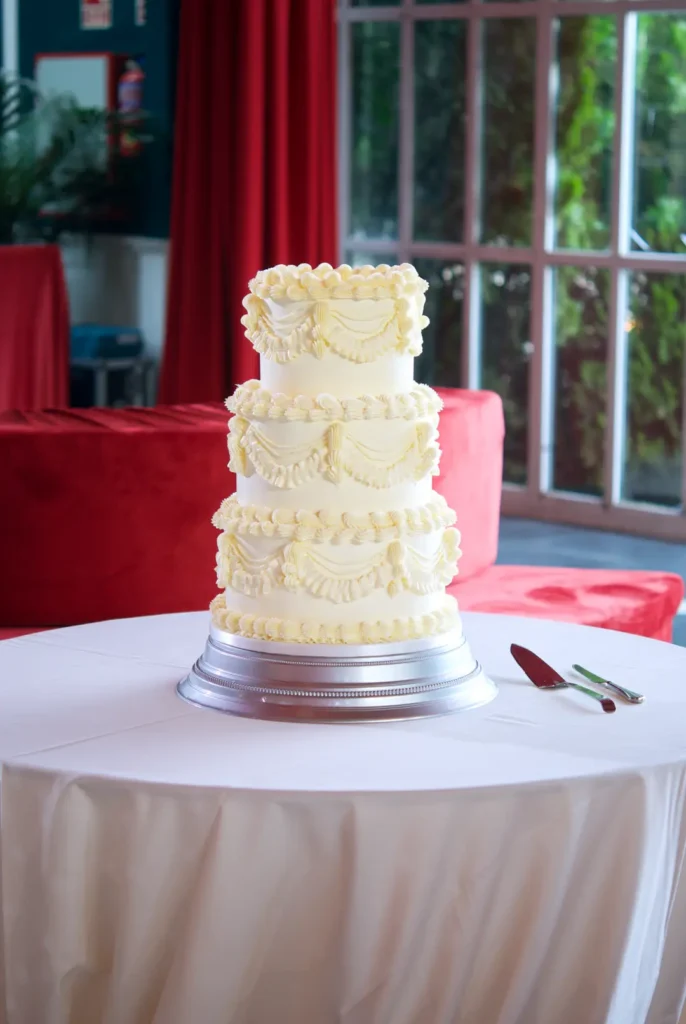 Vintage Lambeth wedding cake presiding over the hall at Castell de Sant Marçal