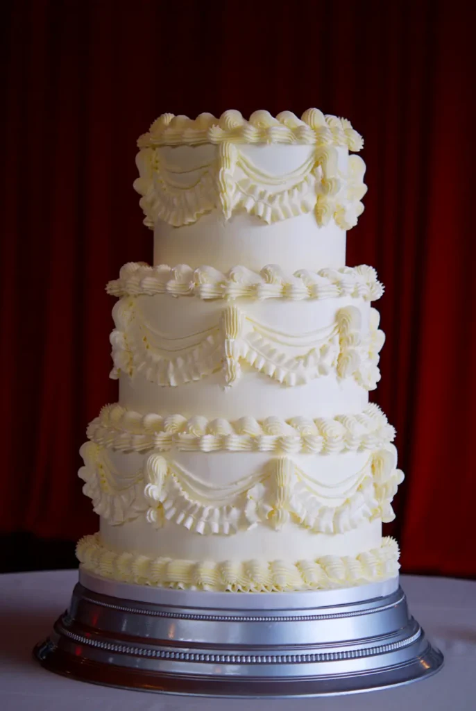 Three-tier Lambeth wedding cake in white buttercream at Castell de Sant Marçal, Barcelona