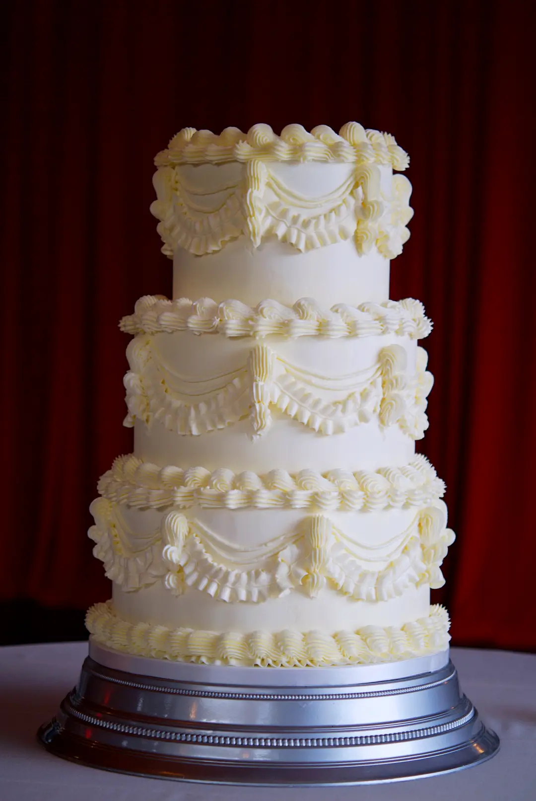 Three-tier Lambeth wedding cake in white buttercream at Castell de Sant Marçal, Barcelona