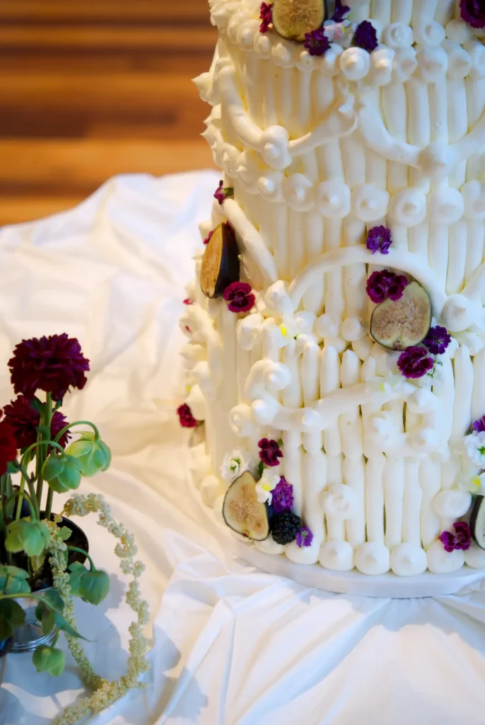 Fresh figs, blackberries and edible snapdragons on a buttercream wedding cake