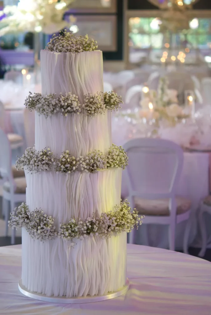 Close-up of wafer paper strips placed by hand on a wedding cake by Mericakes