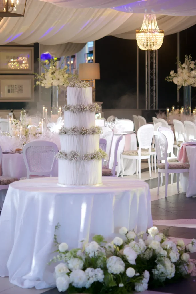 Bespoke white wedding cake with wafer paper volumes in the castle hall