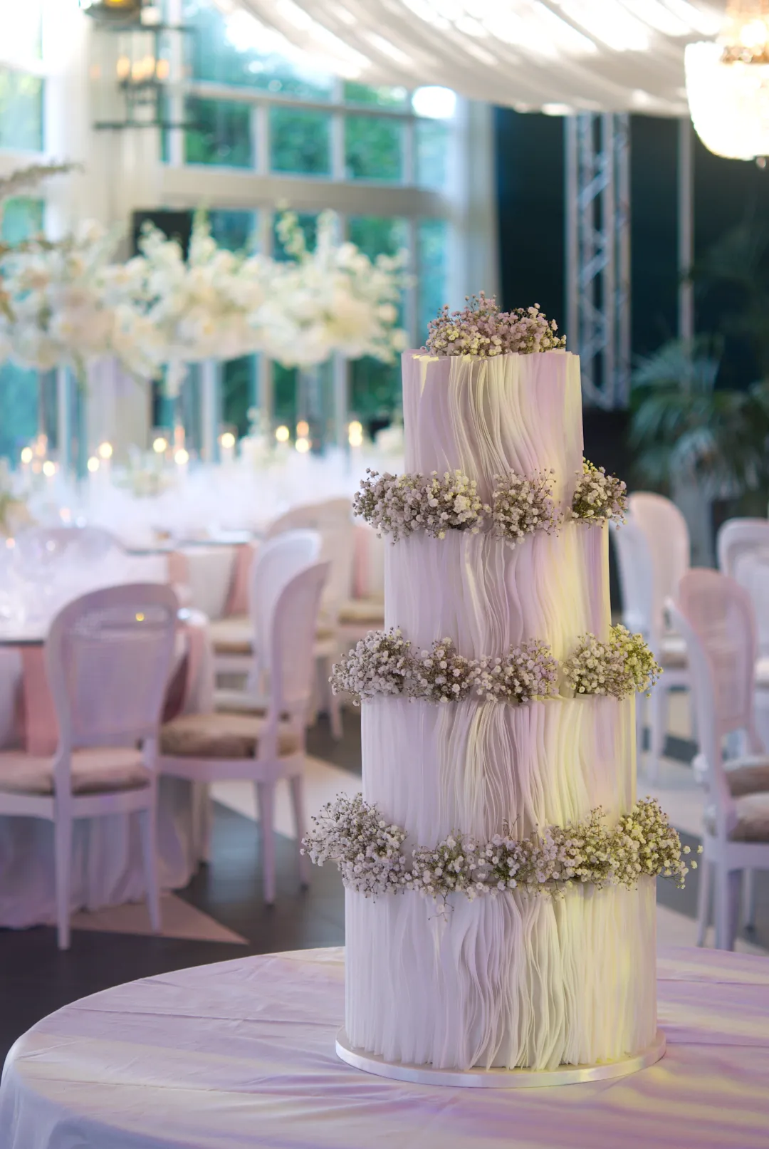 Four-tier luxury wedding cake with hand-placed wafer paper strips at Castell de Sant Marçal, Barcelona