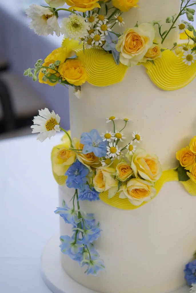 Hand-placed fresh flowers on the tiers of a bespoke wedding cake