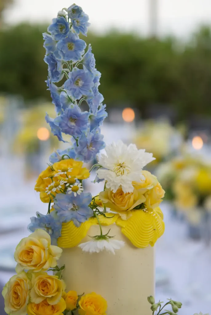 Blue delphinium and white cosmos on a fresh flower wedding cake by Mericakes