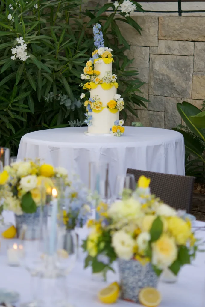 Three-tier yellow and blue wedding cake for a destination wedding on the Costa Brava